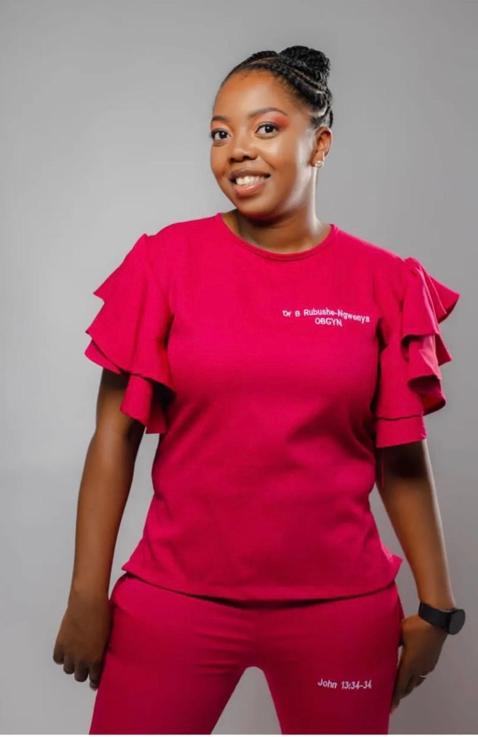Dr Bongi Rubushe-Ngwenya, Obstetrician and Gynaecologist, smiling in a cerise consultation outfit